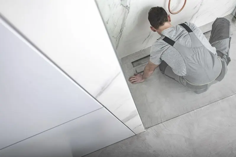 Caucasian men cleaning linear shower drain