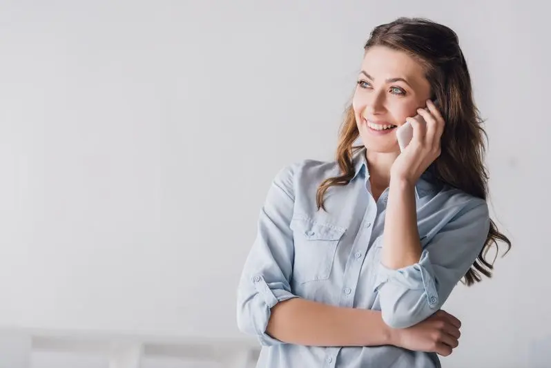 smiling adult woman talking on phone