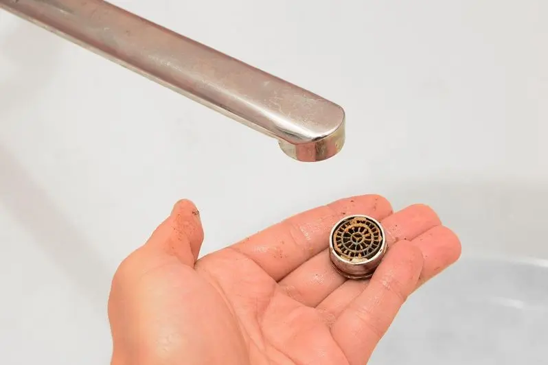 On the palm of the hand is a twisted water aerator