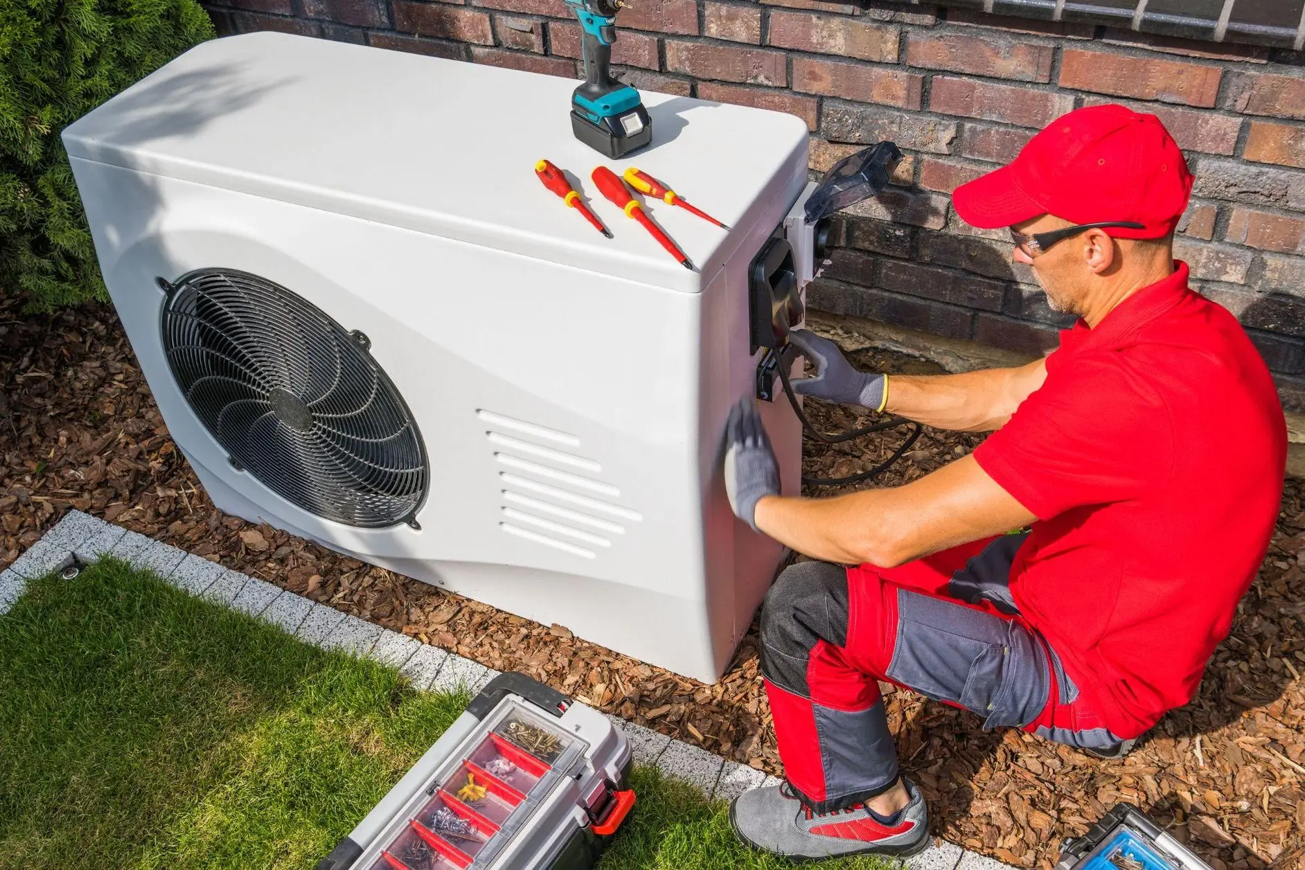 Professional repairing an AC compressor unit