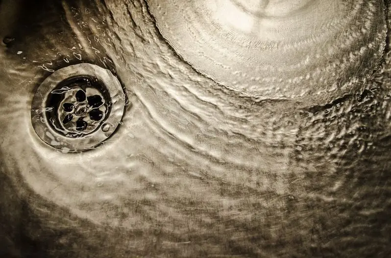 water running into kitchen sink drain