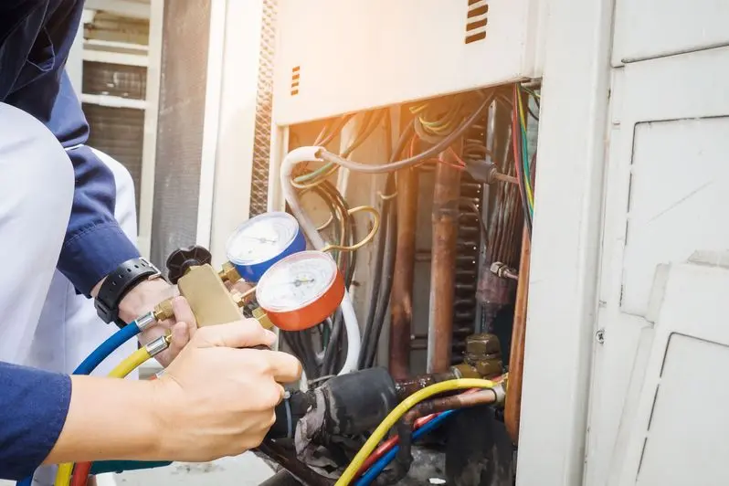 Technician is checking air conditioner ,measuring equipment for filling air conditioners