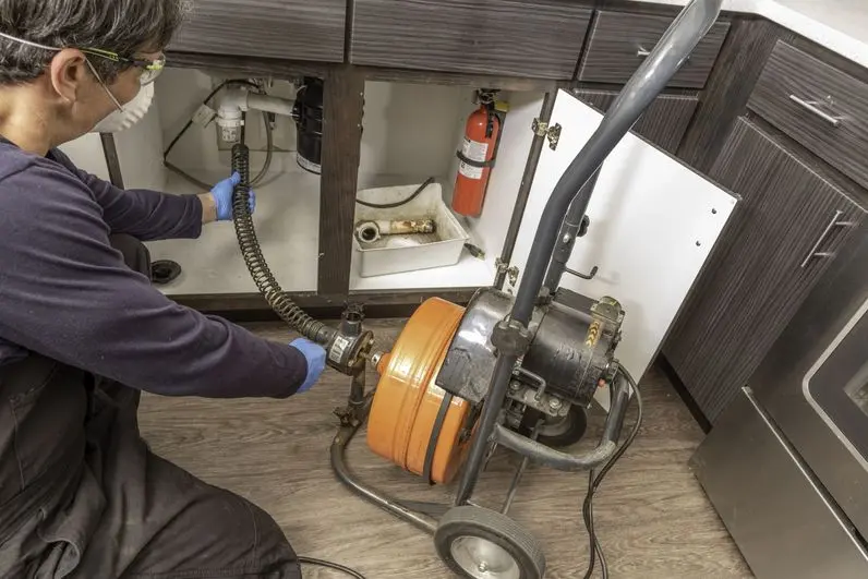 Professional drain cleaning with a self guiding electric snake