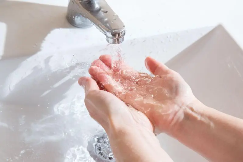 Washing hands in a sink with a low flow faucet