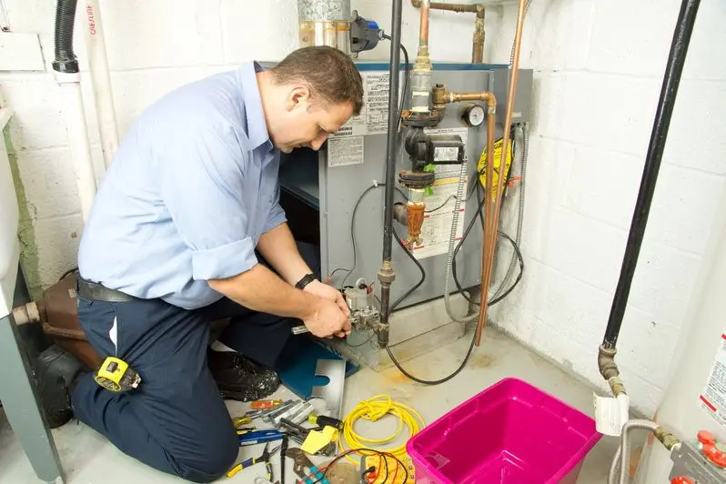 Plumber fixing gas furnace