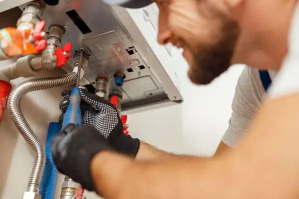 Plumber from Christianson Air Conditioning & Plumbing installing a tankless water heater
