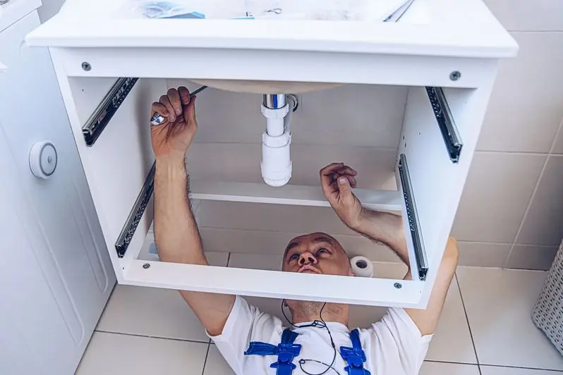 Plumber repairing or installing a bathroom sink