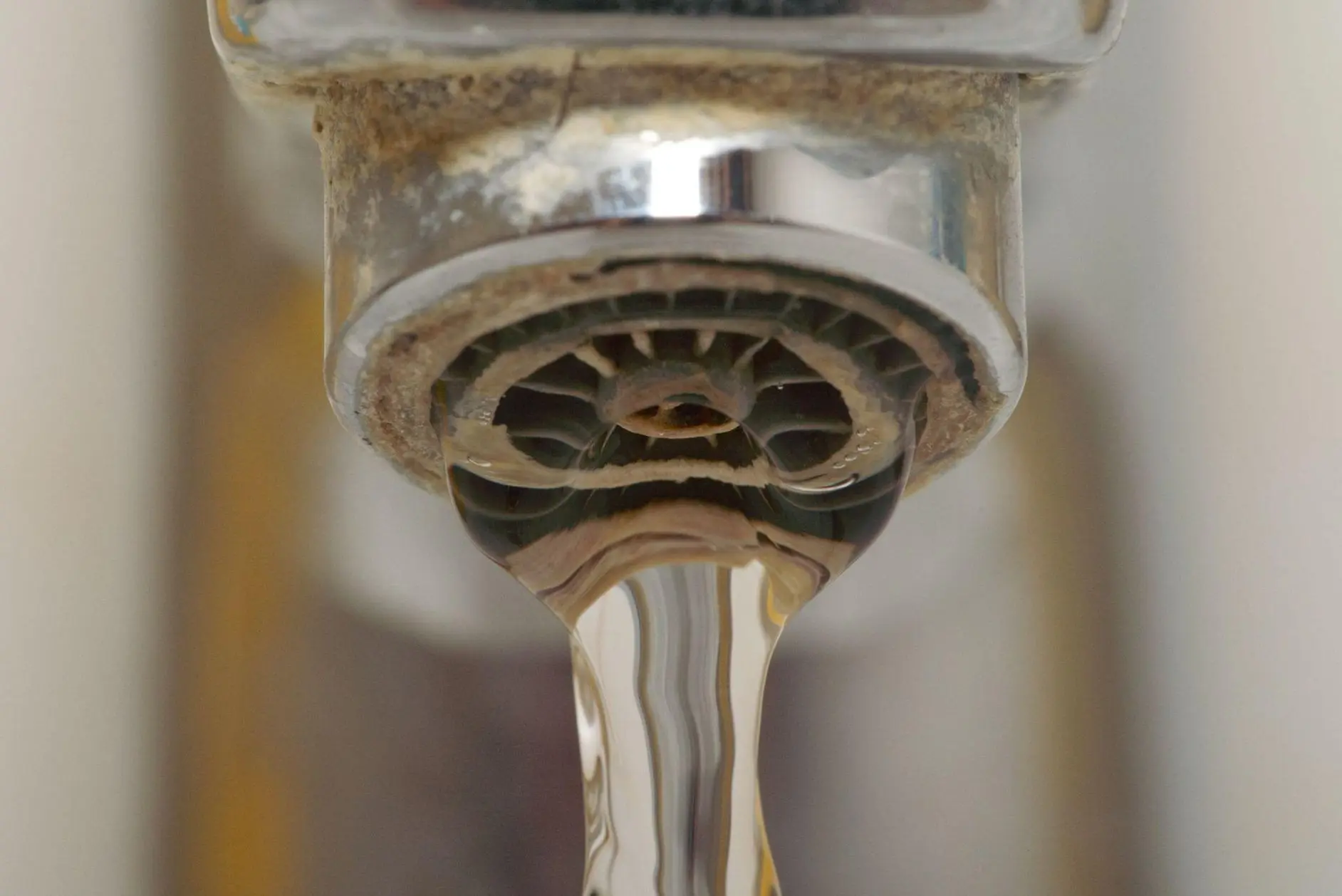 Clogged water filter causing sediment on bathroom sink faucet