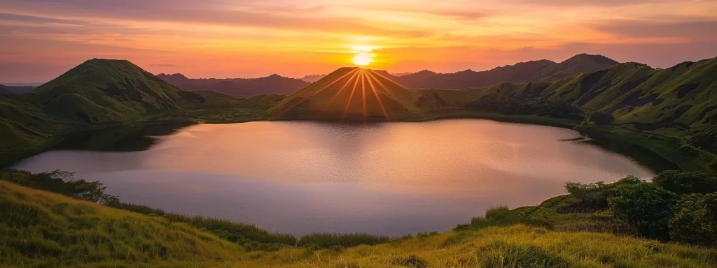 a breathtaking sunset over a tranquil lake, with vibrant orange and pink hues reflecting off the glassy water, surrounded by lush green hills under a clear sky.