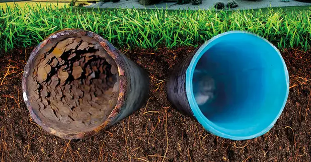 Sewer pipe comparison showing a corroded pipe on the left and a new blue pipe on the right, illustrating the importance of sewer line replumbing services.