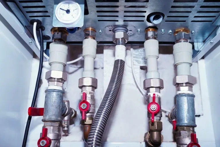 Plumbing connections of a modern domestic double-circuit gas boiler, water heater.