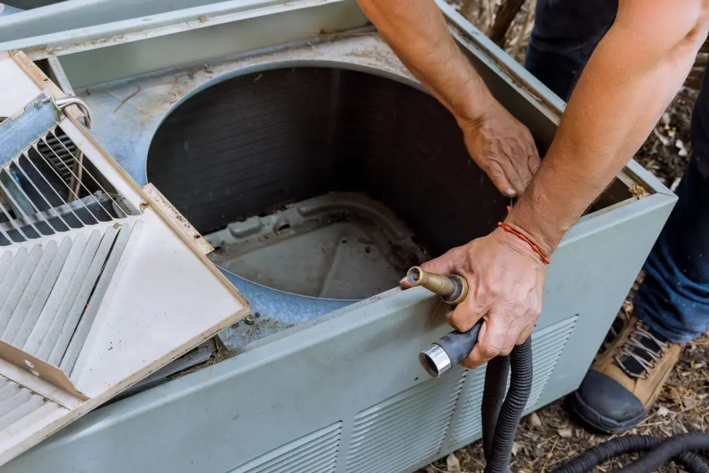 hvac warranty Technician is checking professional man is fixing the air conditioner