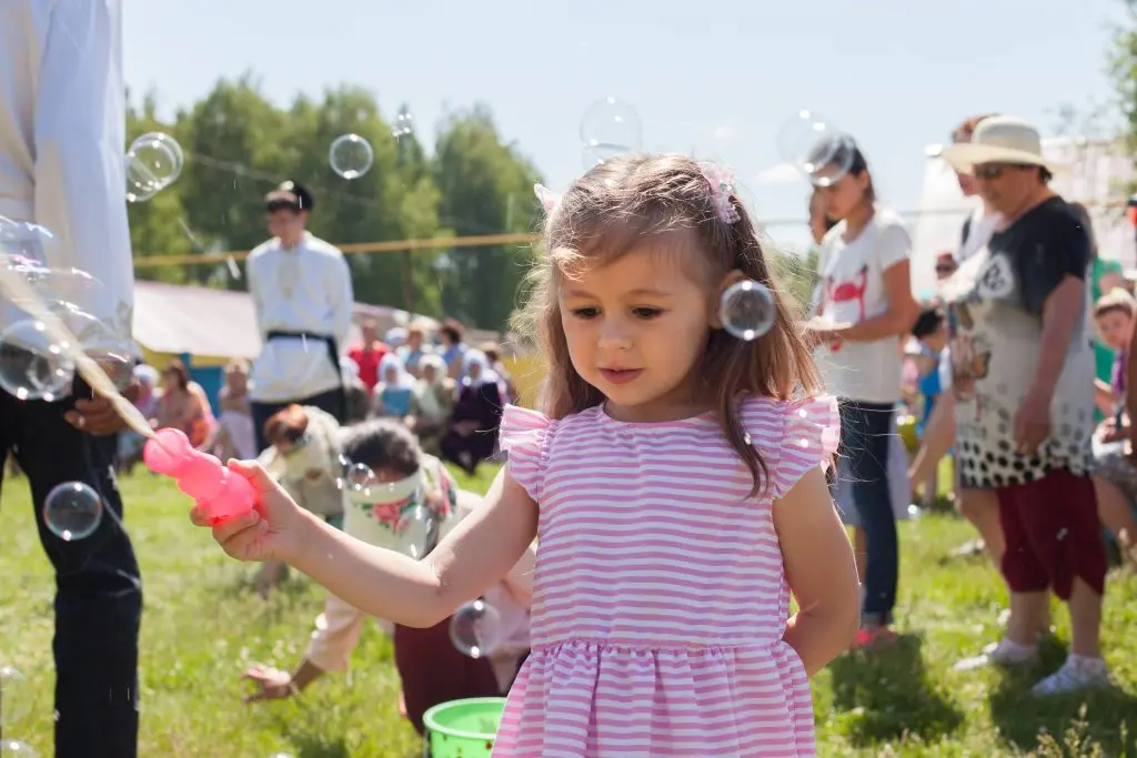 bank of america fall for greenville Little girl plays with soap bubbles at a holiday