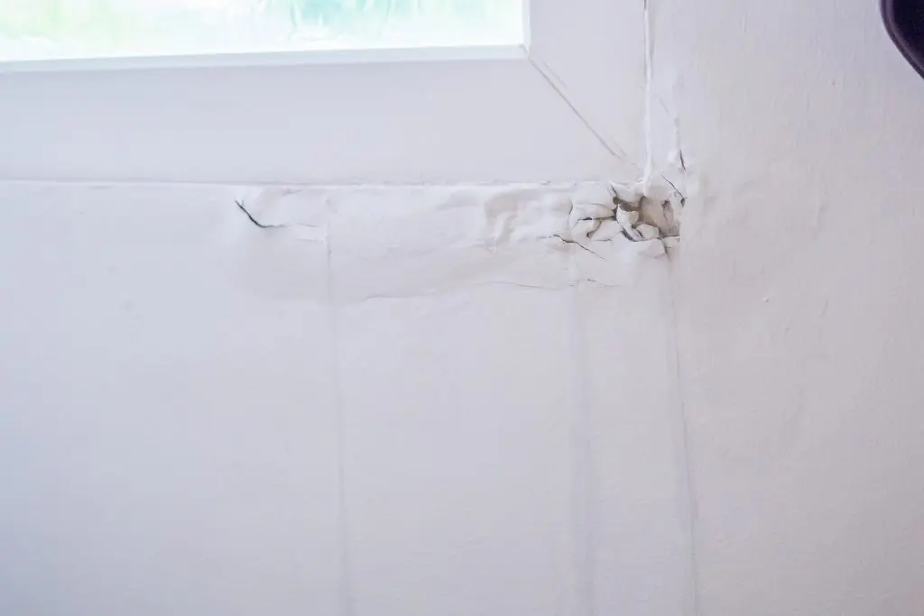 hvac zoning system house wall near the window with some water stain show peeling paint
