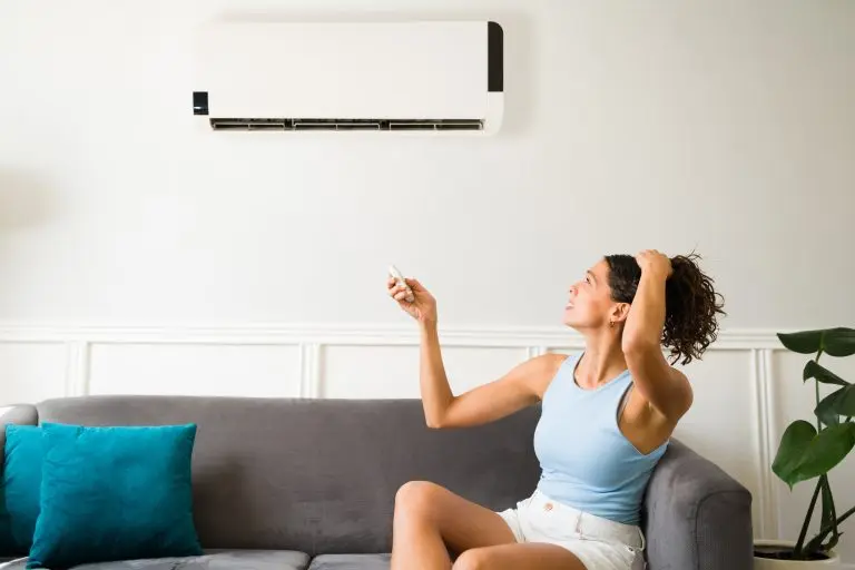 ac not cooling Hot young woman feeling sweaty during a heat wave because her air conditioning is not working