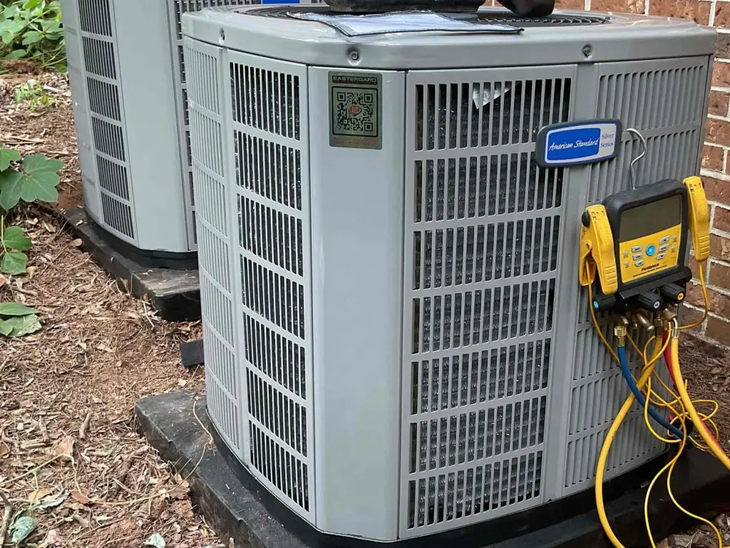 heat pump vs air conditioner grey unit outside house