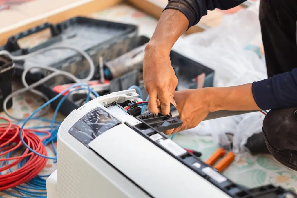 Ac worker doing maintenance