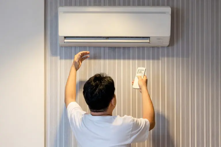 ac short cycling Asian man having a problem with air conditioner is not producing cold air,air conditioning only wind out,refrigerant leaking,dirt and clogging in air filter or malfunctions of the evaporator coil unit