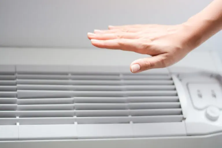 hvac warranty hand in front of unit