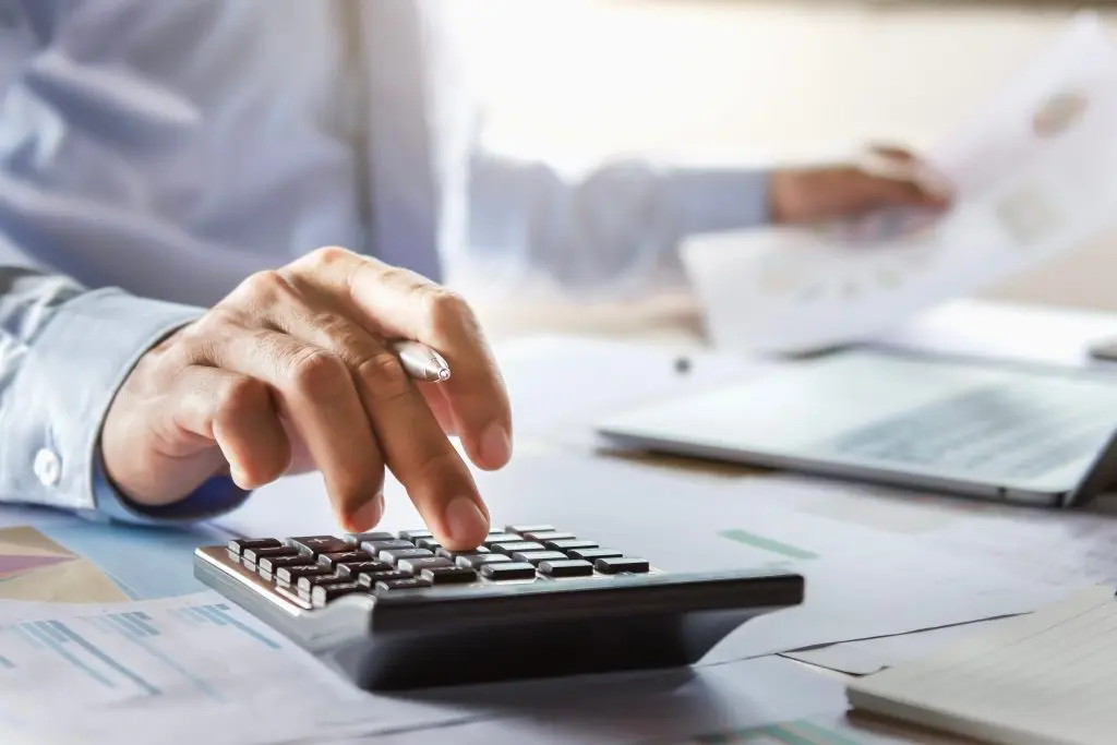 hvac financing options accountant working on desk using calculator for calculate finance report in office