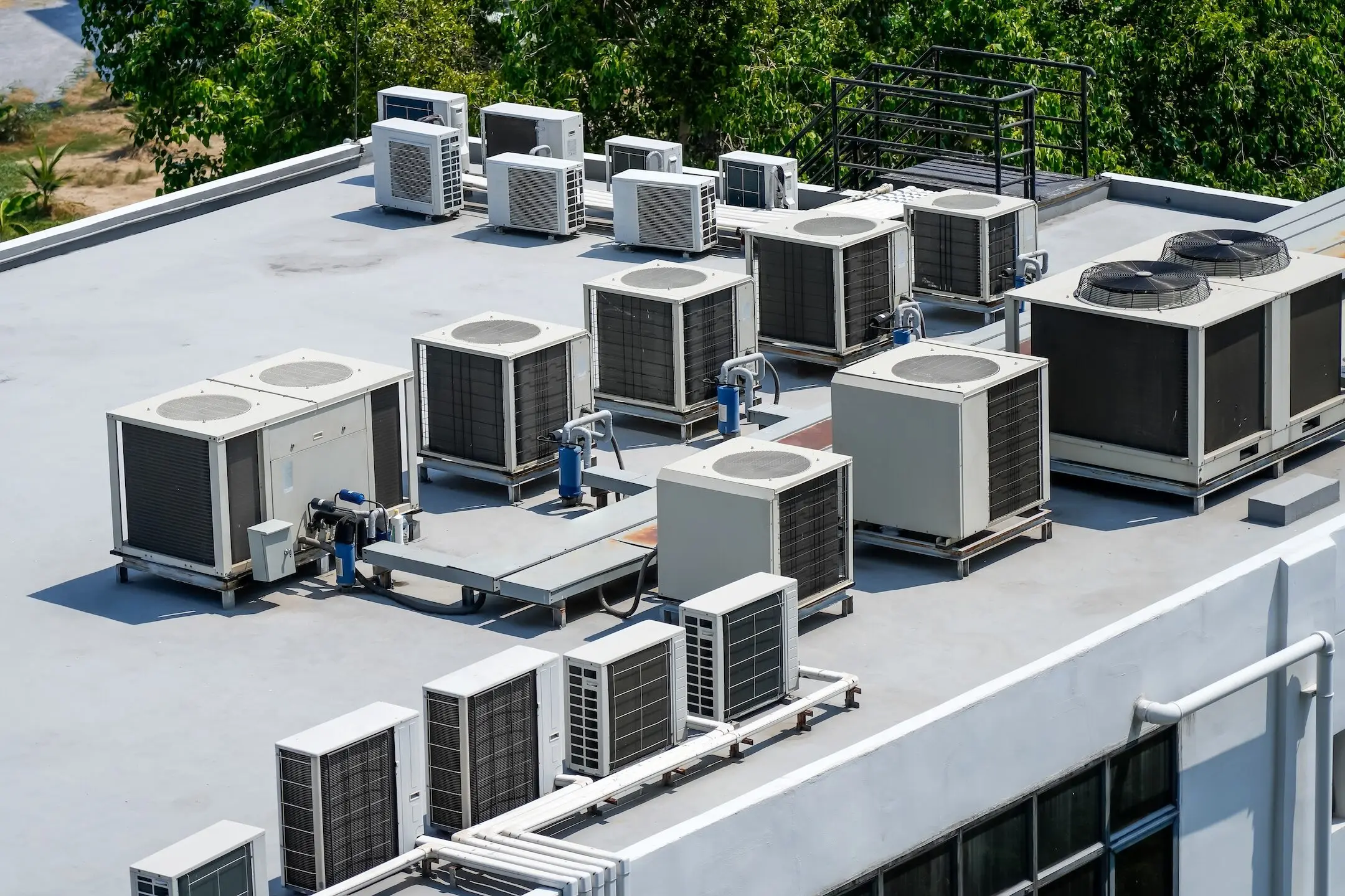 The external units of the commercial air conditioning and ventilation systems are installed on the roof of an industrial building