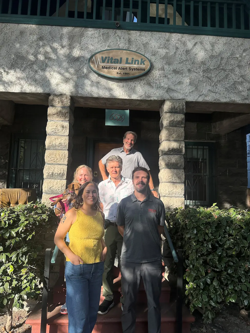 Vital Link medical alert systems in the bay area team standing in front of the Oakland office at 6529 Telegraph Ave