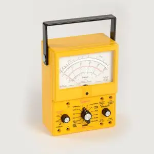 Yellow vintage Simpson analog multimeter with black carrying handle and large dial gauge, used to measure electrical values (volts, ohms, current).