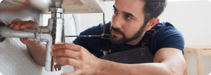 plumber working underneath sink