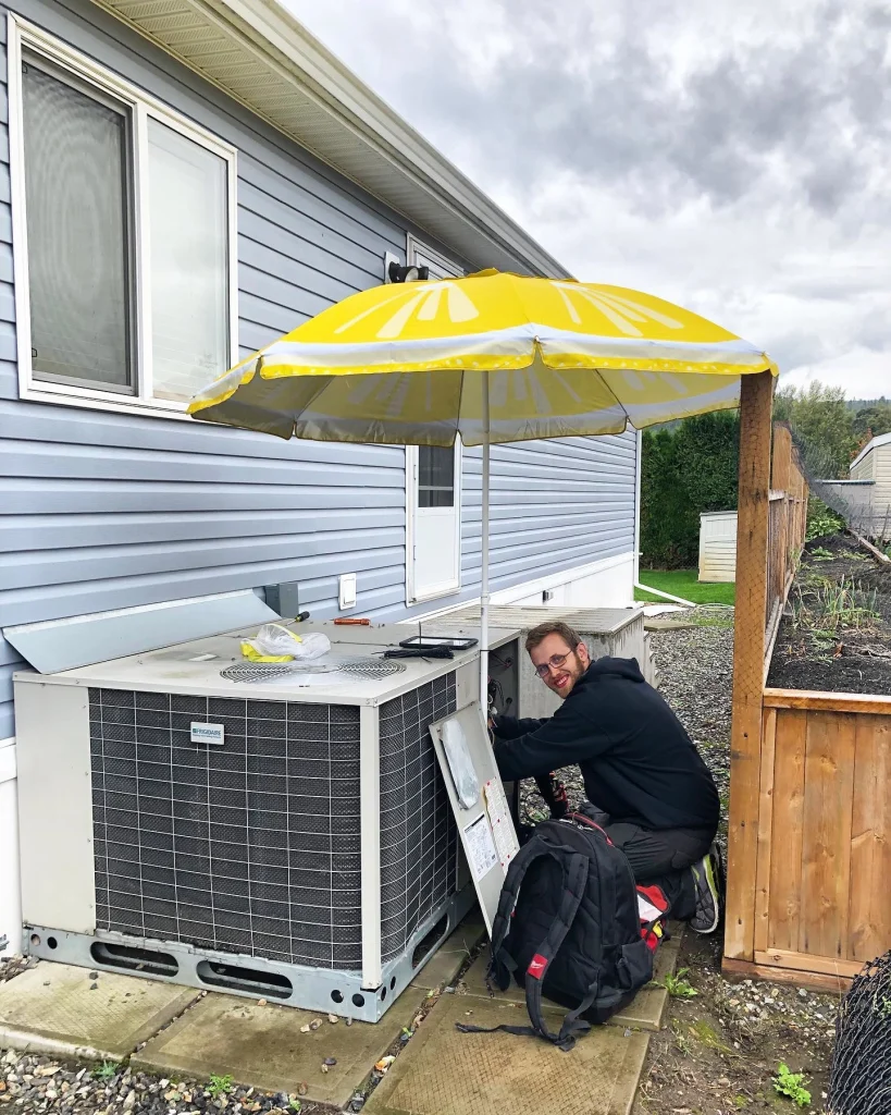 Comfort tech worker servicing an ac unit