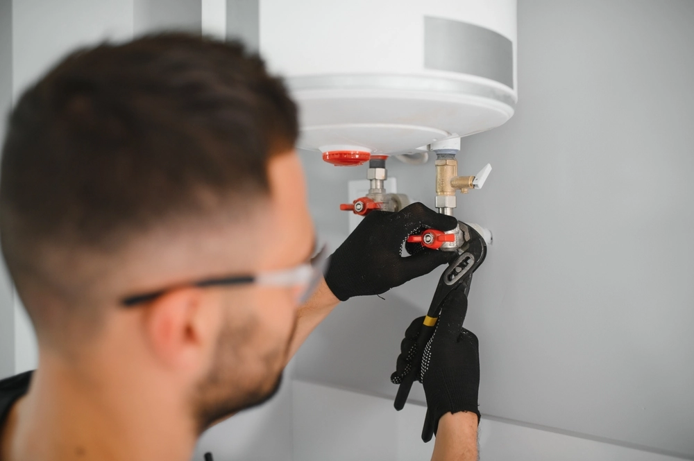 Technician servicing a water heater
