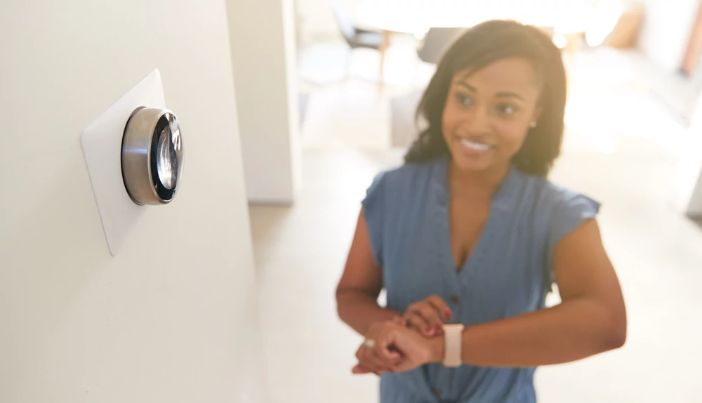 Woman adjusting temperature on her smartwatch