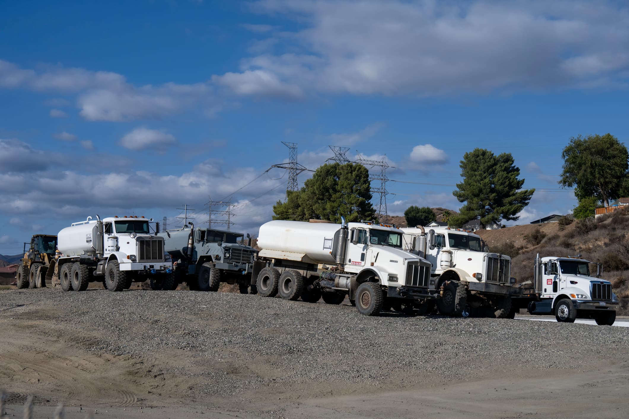 A public works crew is starting to clean out the storm drains in the northern part of the Santa Clarita Valley, California with a bunch of these water trucks
