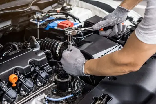mechanic-man-working-on-the-engine-of-the-car-in-the-garage-car-service-and-maintenance-.jpg