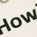 Close-up of printed text saying "HOW TO," relevant to HVAC maintenance tips and service guidance.