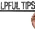 Hand holding a sign that reads "Helpful Tips," related to HVAC advice for home comfort and maintenance.