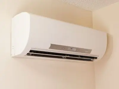 Ductless mini-split air conditioning system mounted on a wall, illustrating modern cooling technology for home comfort and efficiency.