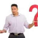 Man holding a large red question mark, symbolizing inquiries about HVAC system selection and installation.