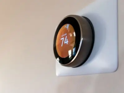 Smart thermostat displaying temperature setting of 74 degrees, illustrating energy-saving technology for efficient HVAC management.