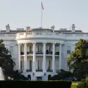 White House exterior showcasing its iconic architecture and flag, relevant to HVAC history and cooling facts.