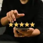 Person using smartphone to rate HVAC services with five gold stars, reflecting customer satisfaction for Mid Florida A/C.
