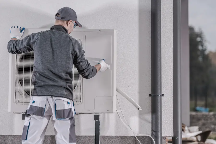 Technician replacing an AC