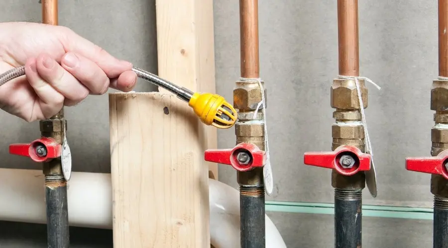 Gas leak detection with flexible hose and sensor on copper pipes, RupCoe plumbing services.