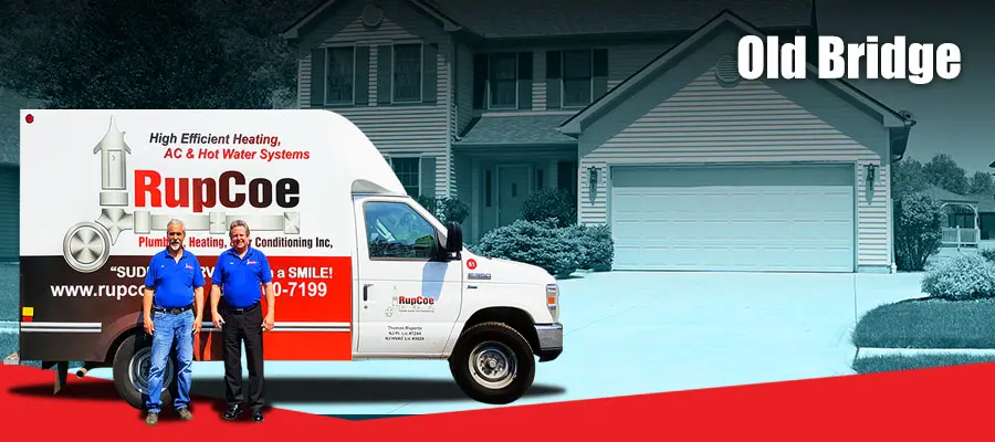 RupCoe Plumbing, Heating & Air Conditioning service van in Old Bridge, featuring two technicians in front of a residential home, emphasizing emergency plumbing and HVAC services.