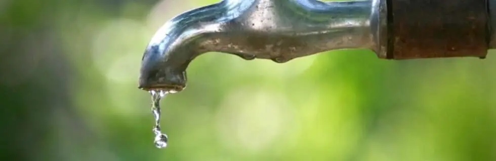 Outdoor plumbing faucet dripping water, highlighting maintenance needs amid summer challenges.