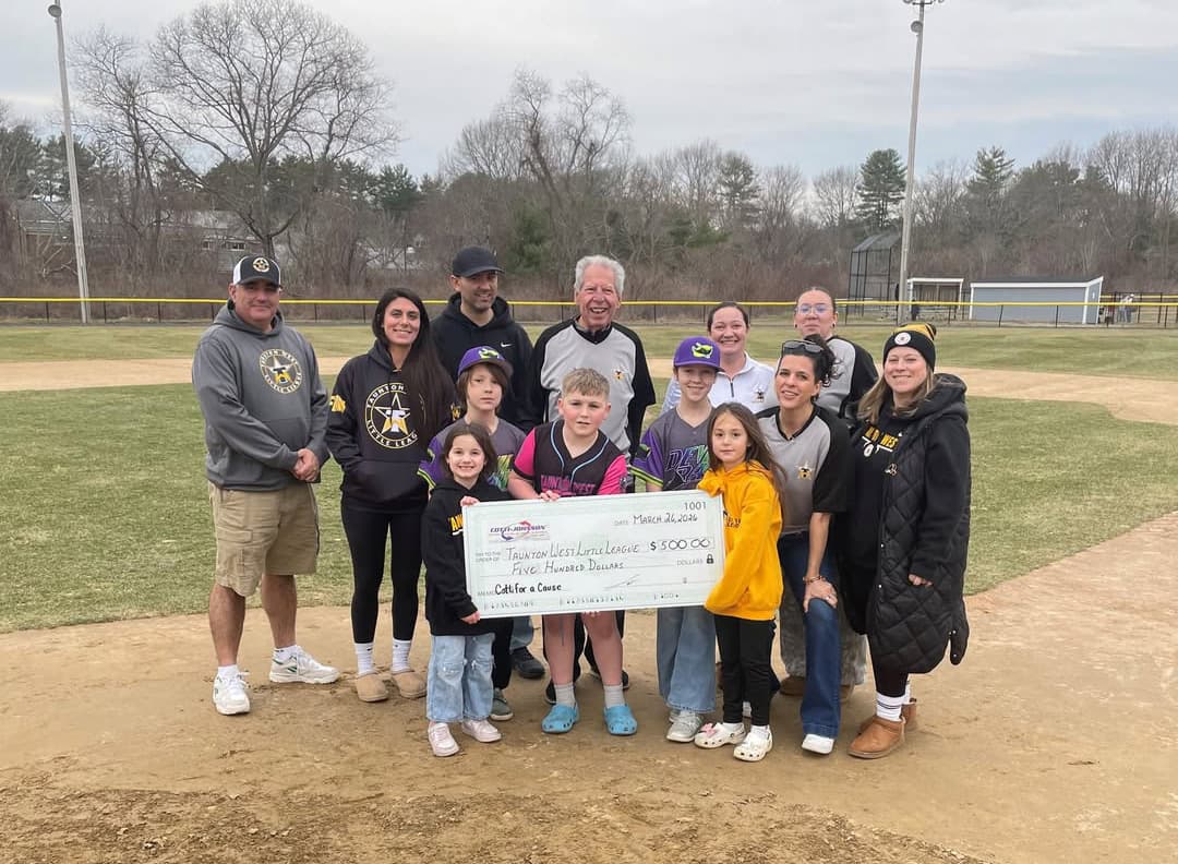 Group of adults and children holding a large check for $500, supporting Taunton West Little League, on a baseball field, showcasing community engagement by Cotti Johnson HVAC, Inc.