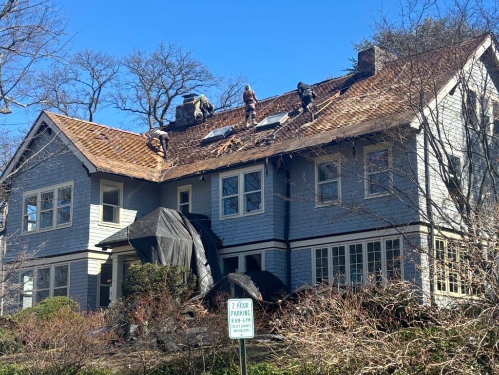 workers replacing roof
