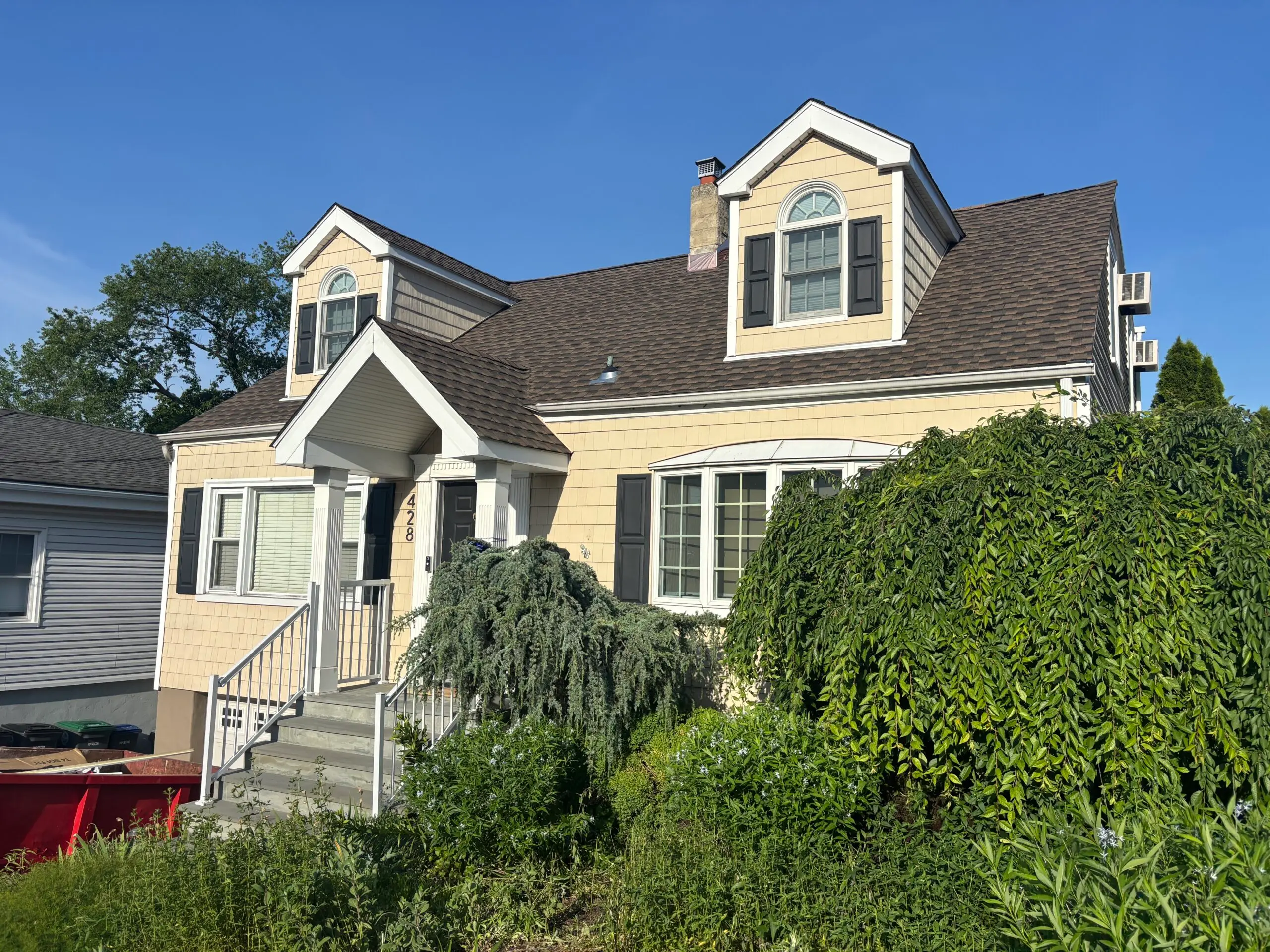 brown shingles roof and light yellow wall