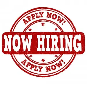 Red circular stamp graphic with bold text "NOW HIRING" and "APPLY NOW!" emphasizing employment opportunities at Jim Wagner Plumbing, Inc. in Chicago.