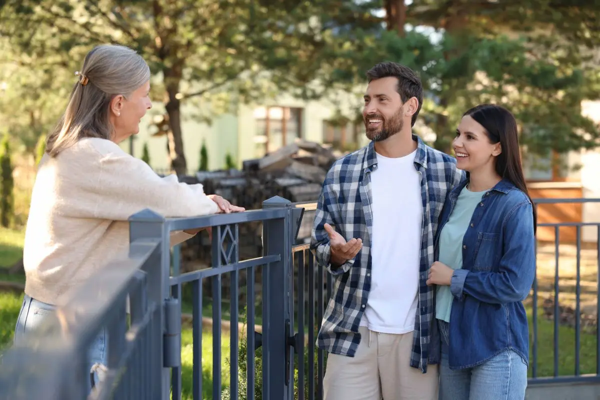 couple talking near fence mature woman