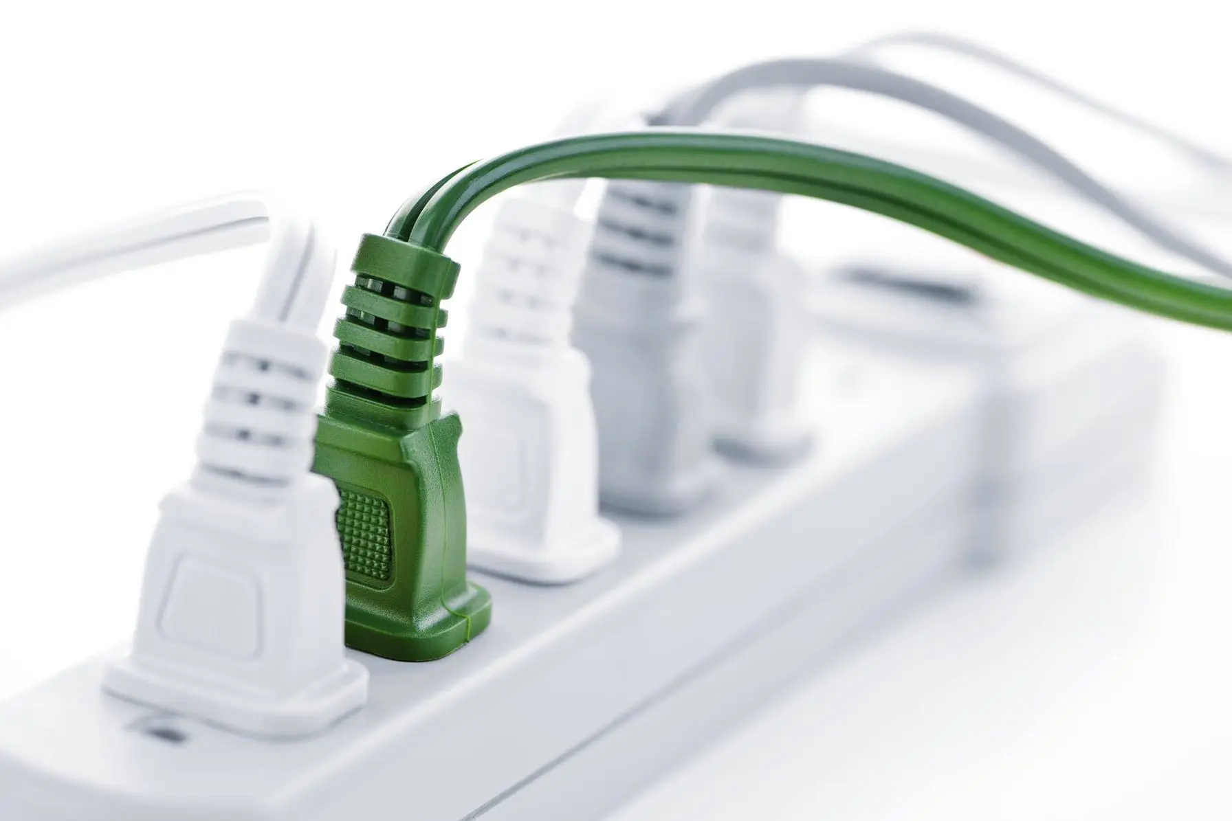 Multiple power cords plugged into an electric power bar